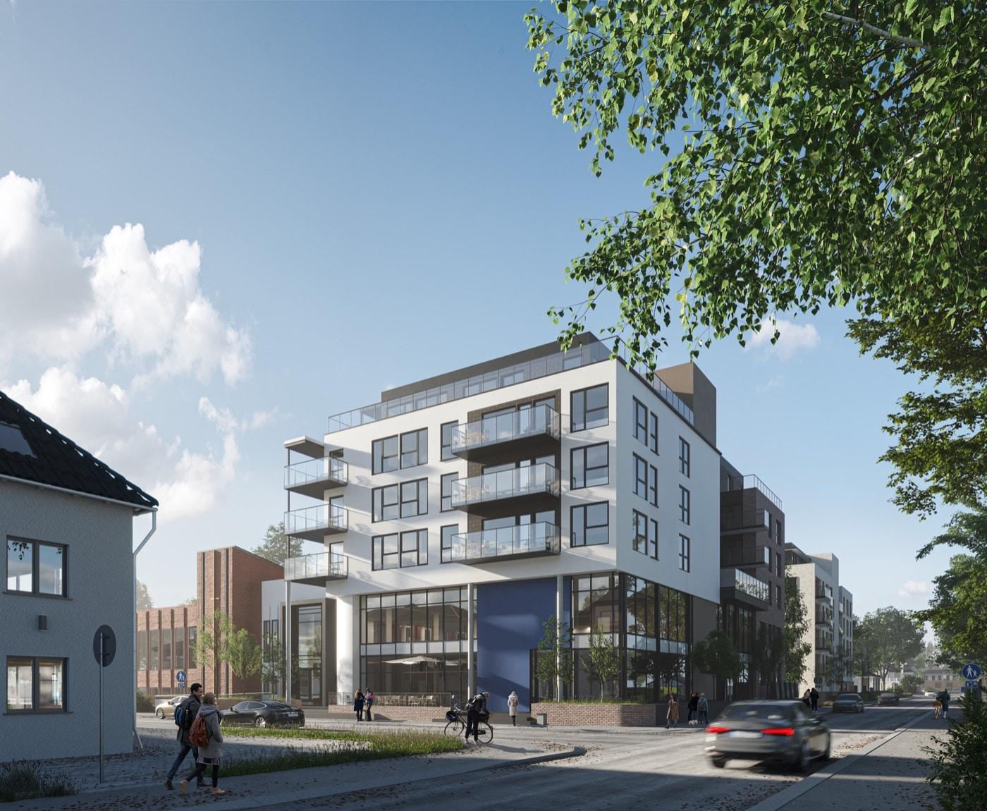 A white apartment building with balconies on a Larvik street corner