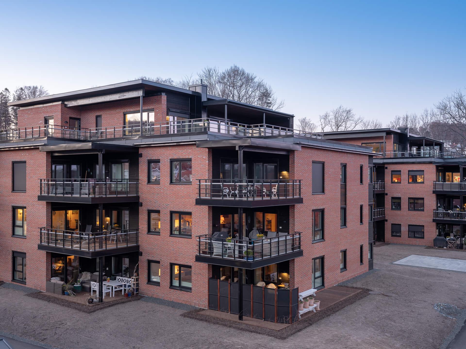 Brick apartment blocks with balconies at dusk